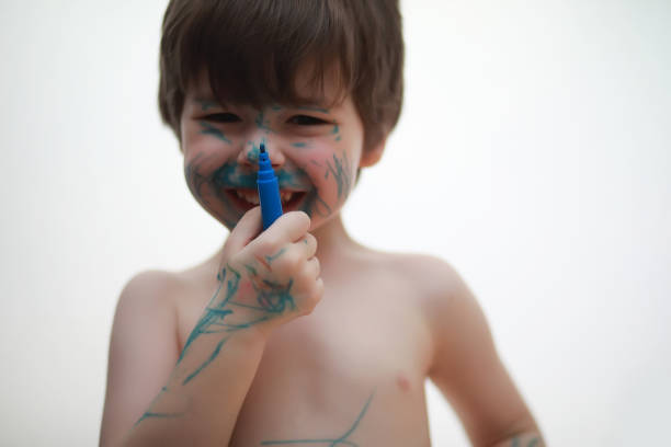 istock A child painted his face with colors 1166057391