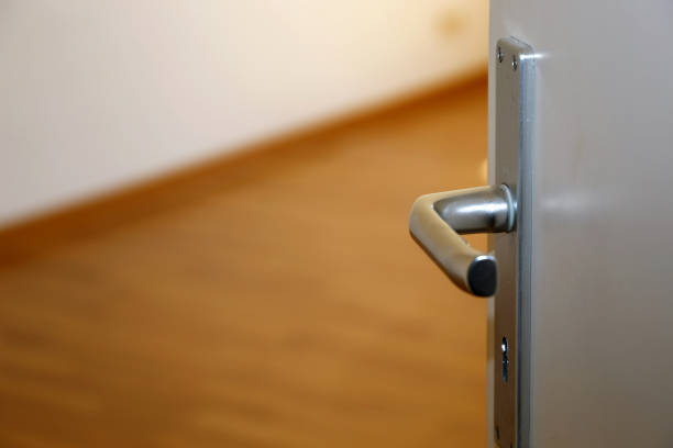 istock Half open door in an empty apartment 1166062391