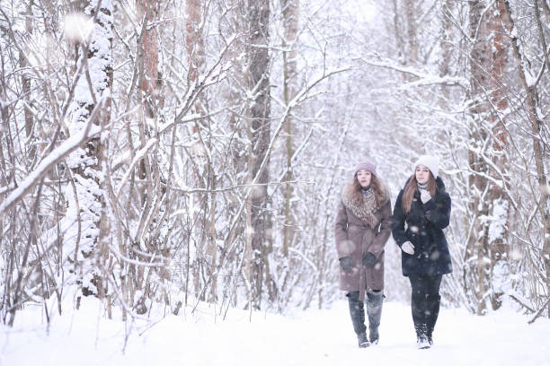 istock Girl in a winter park in snowfall 1166063864