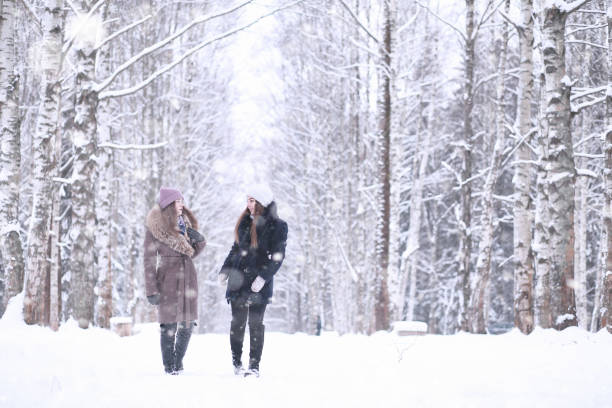 istock Girl in a winter park in snowfall 1166064085