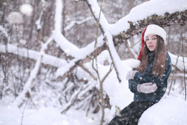 istock Girl in a winter park in snowfall 1166064314