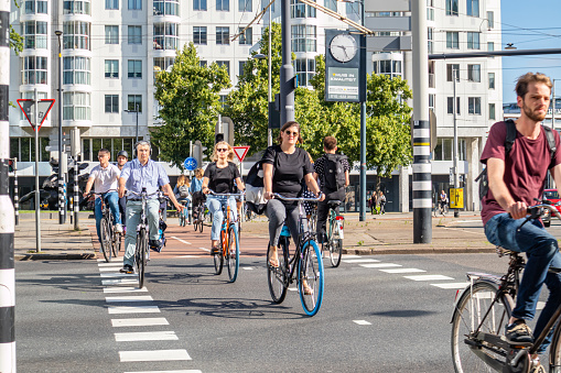 Rotterdam, Netherlands. June 27, 2019. People riding bikes in the city center, Spring sunny day