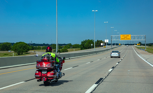 USA Highway in Texas, May 13th, 2019. Rear view of a biker riding a moto to Amarillo