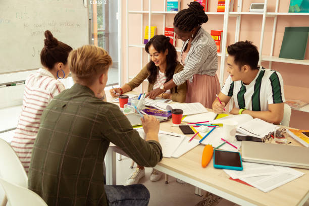 istock Cheerful international tutor consulting her new student 1166070822