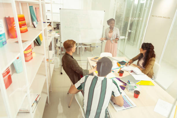 istock Positive delighted young people studying in language school 1166070839