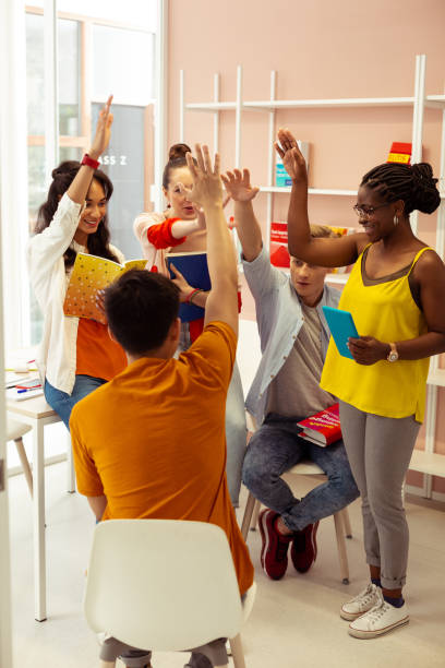 istock Happy mixed-raced group celebrating their good results 1166070879
