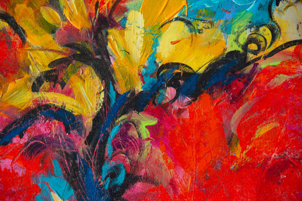 Close up of easel, picture with flowers, painting brushes on dark background. Hobby concept