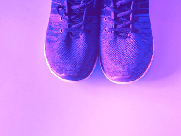istock Purple trainers on monochrome background. 1166071224