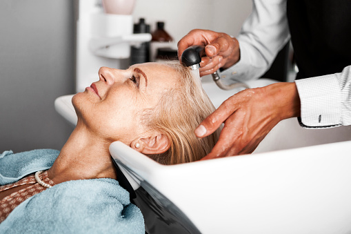 Hair stylist washing hair