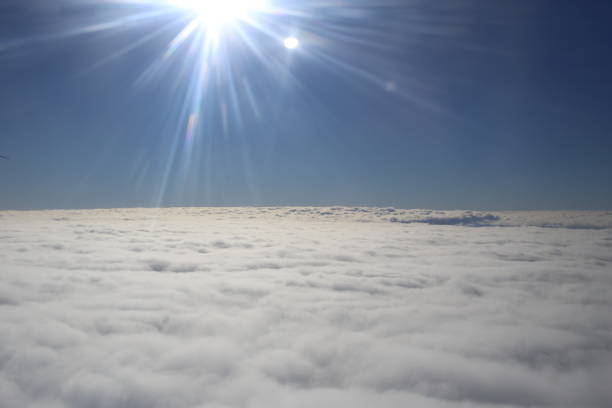 istock bright sunbeams flying sky above the clouds 1166072966