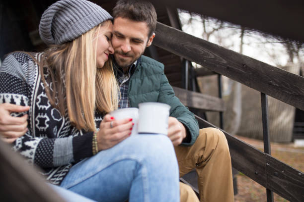 istock Happy couple drinking hot tea outdoor on cozy camping 1166073149