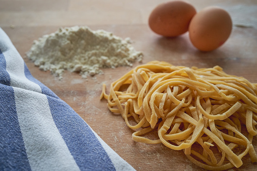 Handmade stringozzi (or strangozzi), an Italian wheat pasta similar to noodles, among the more notable of those produced in the Umbria region. Landscape format.