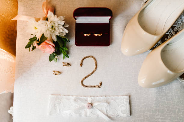 istock Wedding accessory bride. Stylish shoes, earrings, chain, gold ring, garter, on table standing on white background. flat lay. top view. 1166073236