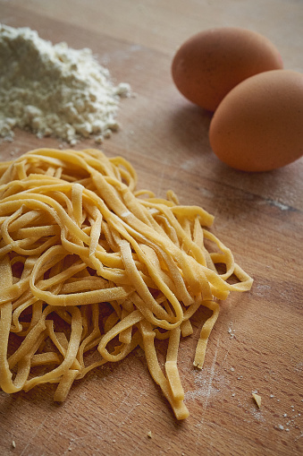 Handmade stringozzi (or strangozzi), an Italian wheat pasta similar to noodles, among the more notable of those produced in the Umbria region. Portrait format.
