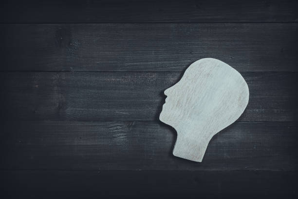 istock Human head and face on wood table background. Symbol of Process and Positive Mind concept 1166073263