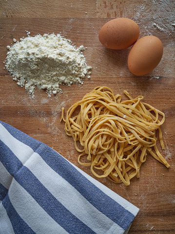 Handmade stringozzi (or strangozzi), an Italian wheat pasta similar to noodles, among the more notable of those produced in the Umbria region. Portrait format.