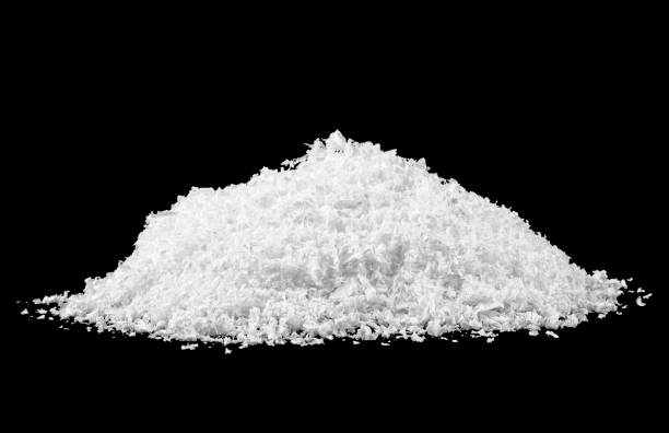 istock Heap of white snow isolated on black background 1166076160