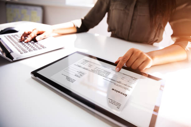 Businesswoman Checking Invoice On Digital Tablet Close-up Of A Busineswoman's Hand Working With Invoice On Digital Tablet bill stock pictures, royalty-free photos & images