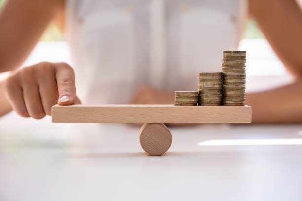 istock Businessperson Balancing Increasing Stacked Coins With Finger 1166079251