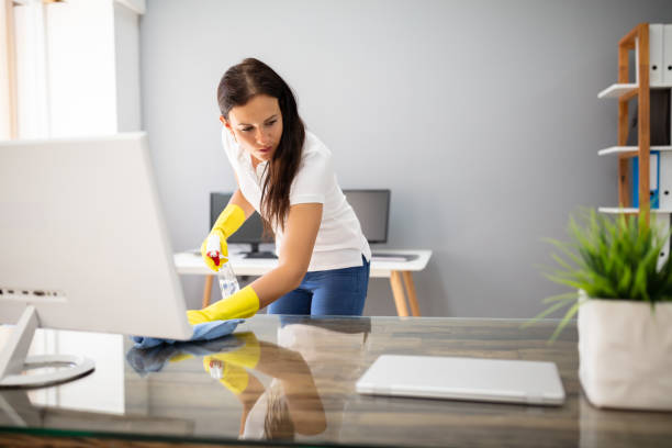 istock Janitor Cleaning Desk With Napkin 1166079304