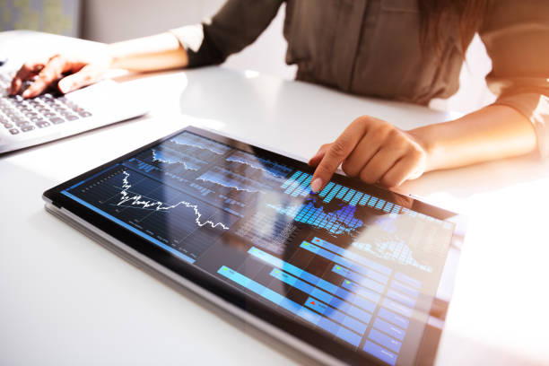istock Person's Hand Pointing On Graph At Tablet 1166079361