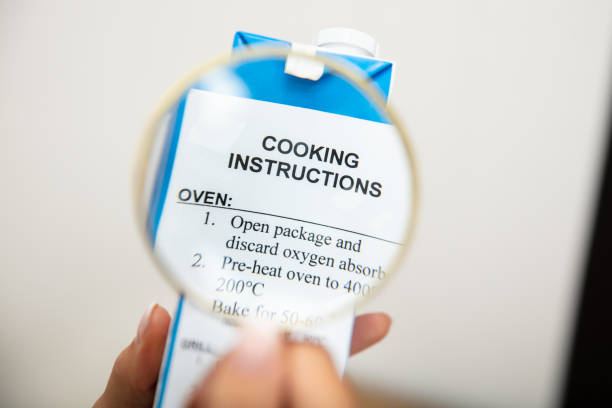 istock Human Holding Magnifying Glass Over Cooking Instructions 1166079408