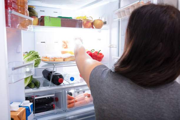 istock Woman Taking Food From Refrigerator 1166079441