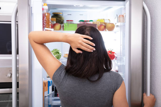 istock Woman Searching For Food In Refrigerator 1166079471