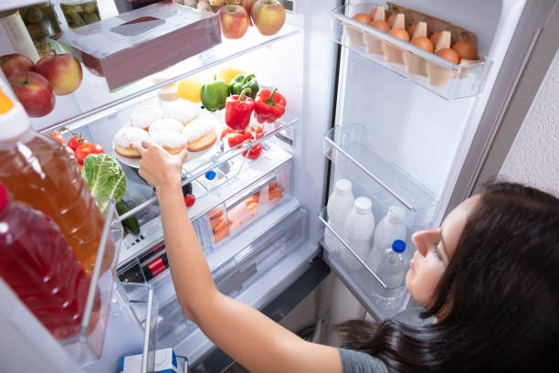 istock Woman Taking Food From Refrigerator 1166079479