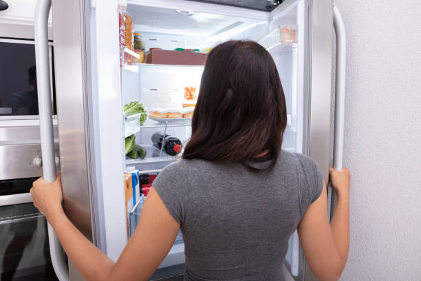 istock Woman Looking At Food In Refrigerator 1166079488