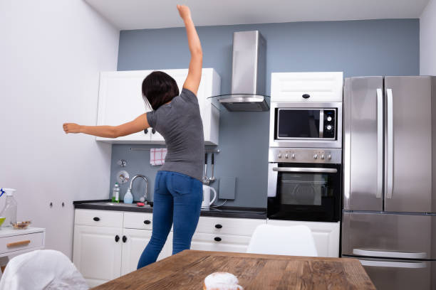 istock Woman Jumping In The Kitchen 1166079543