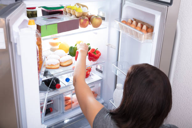 istock Woman Taking Food From Refrigerator 1166079648