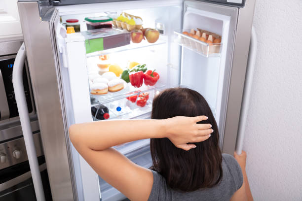 istock Woman Searching For Food In Refrigerator 1166079691