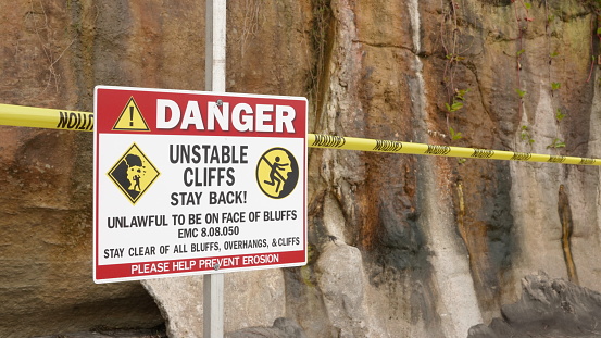 Close up of a danger and warning sign on Grandview Beach, Encinitas, CA / USA, at the site of a deadly bluff collapse on August 2, 2019, which killed three people. Photo taken on August 3, 2019.