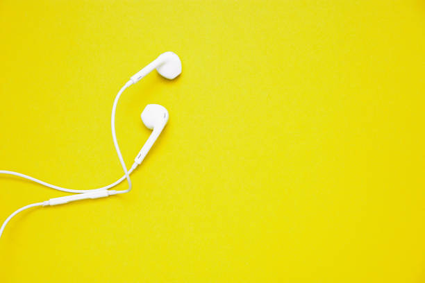 istock white headphones on yellow background with copy space 1166084373