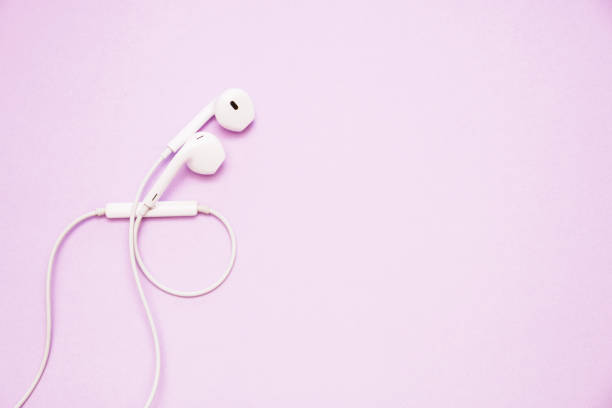 istock white headphones on pink background with copy space 1166084500