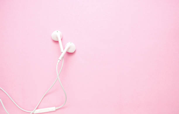 istock white headphones on pink background with copy space 1166084575