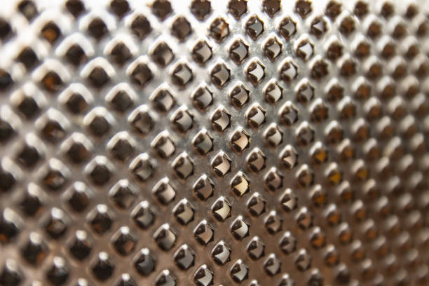 istock Texture of a metal surface with holes. Kitchen grater. Selective focus. 1166087512