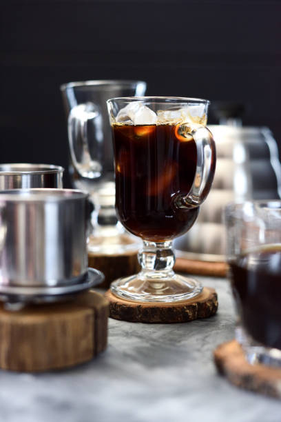 istock Making Vietnamese black drip ice coffee in irish mug on black background 1166087537