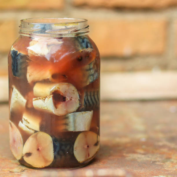 istock mackerel, fresh salted fish in a jar (pieces in brine). top view. food background 1166088443