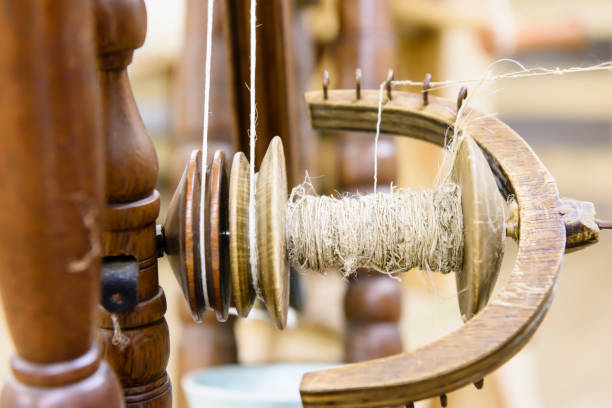 Linen thread being spun and wound onto a traditional bobbin in Ireland