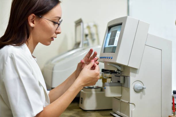 Ophthalmic technician checks the glass on the machine