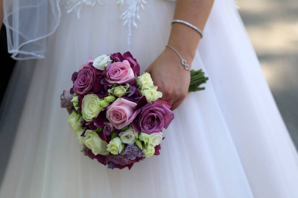 istock The bride holds a wedding bouquet in her hand 1166091508