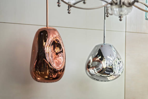 istock Different modern streamlined mirror copper chandeliers. Metal copper shaped pendant lamps. Loft style 1166092520