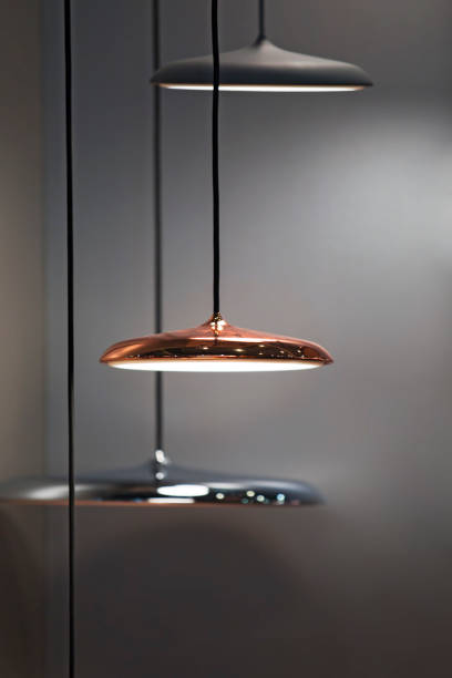 istock Different modern streamlined mirror copper chandeliers. Metal copper disk shaped pendant lamps. Loft style 1166092545