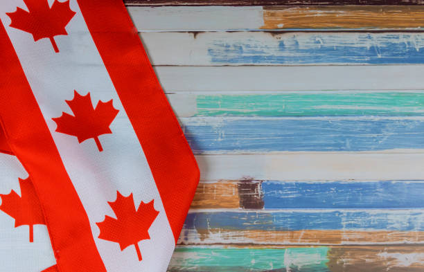 Canadian red and white flag against dark rustic background for Canada Day celebration and national holidays Canada Day celebration and national holidays Canadian red and white flag against dark rustic background for victoria day canada photos stock pictures, royalty-free photos & images