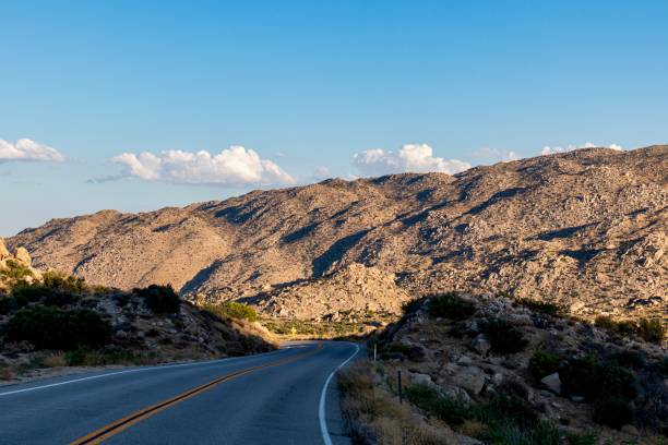Winding desert highway during sunset A deserted and winding, curvy highway in the California Desert with the setting sun illuminating the desert mountains in the Anza Borrego Desert. borrego springs photos stock pictures, royalty-free photos & images