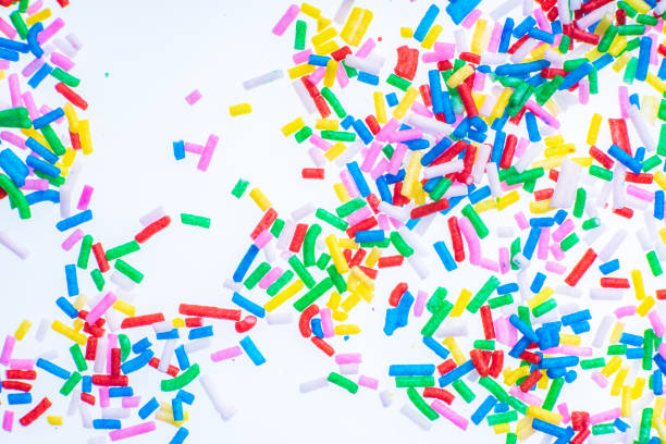istock Colorful candy sprinkles close up for birthday cake on white background 1166095824