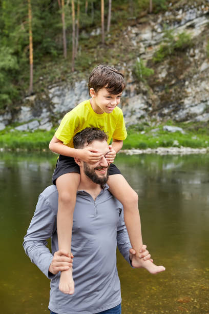 istock Father and son are walking near river. 1166097596