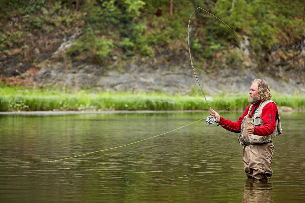 istock Flyfishing in waterproof clothing in river. 1166097601